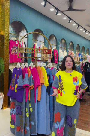 Multicolor Printed Ethnicwear Rack Display – Bold Floral & Abstract Garments in Boutique Interior with Teal-Gold Accents