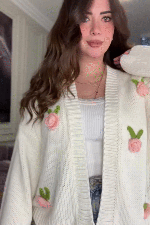 White Knit Cardigan with Pink Floral Appliqué 🌸🤍 – Button-Up Layer Styled with Gold Necklaces & Light Denim